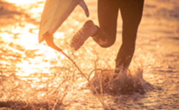 a distorted image of a person running in water with a paddleboard 