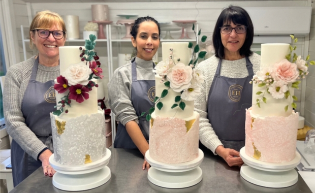 Bakers posing with cakes from Elizabeth Harris Wedding Cakes 