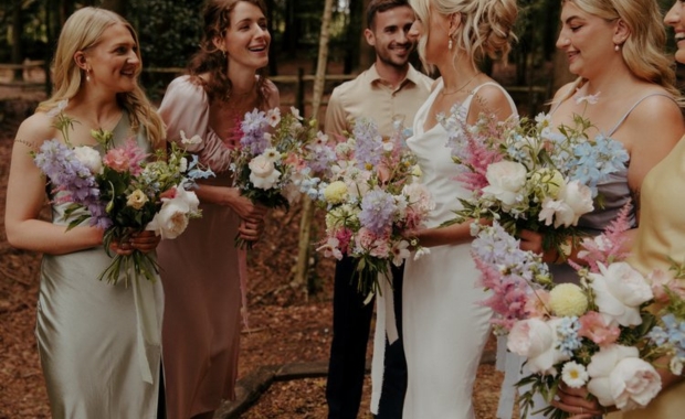 A group holding bouquets by Frank